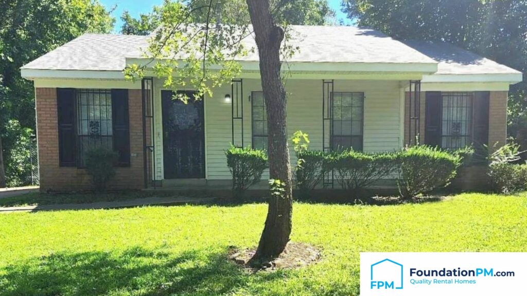 Property owner smiling confidently with a well-maintained property in the background.