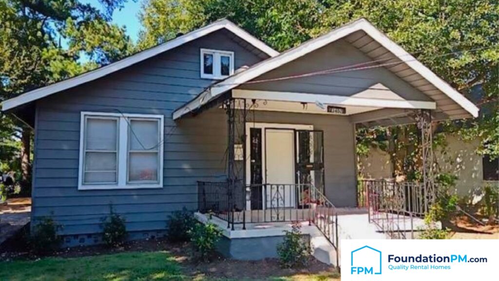 A happy landlord shaking hands with a property manager in front of a well-maintained rental property.